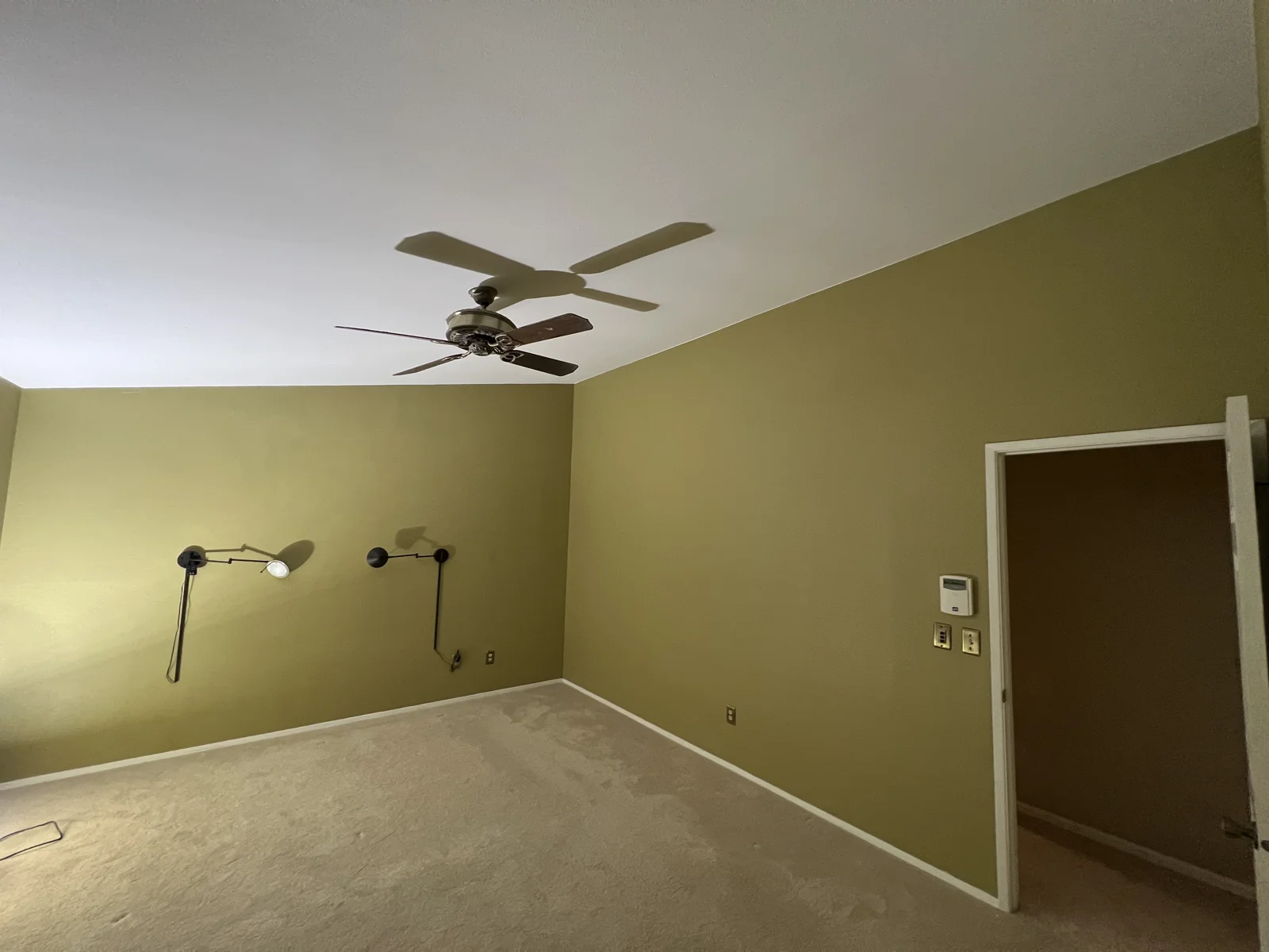 Olive-green bedroom walls with white ceiling and trim